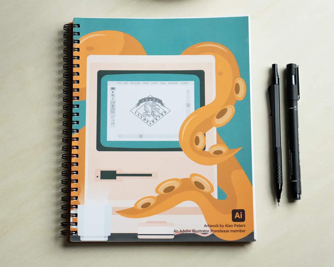 An illustration of an octopus interacting with a vintage computer on a spiral-bound notebook.