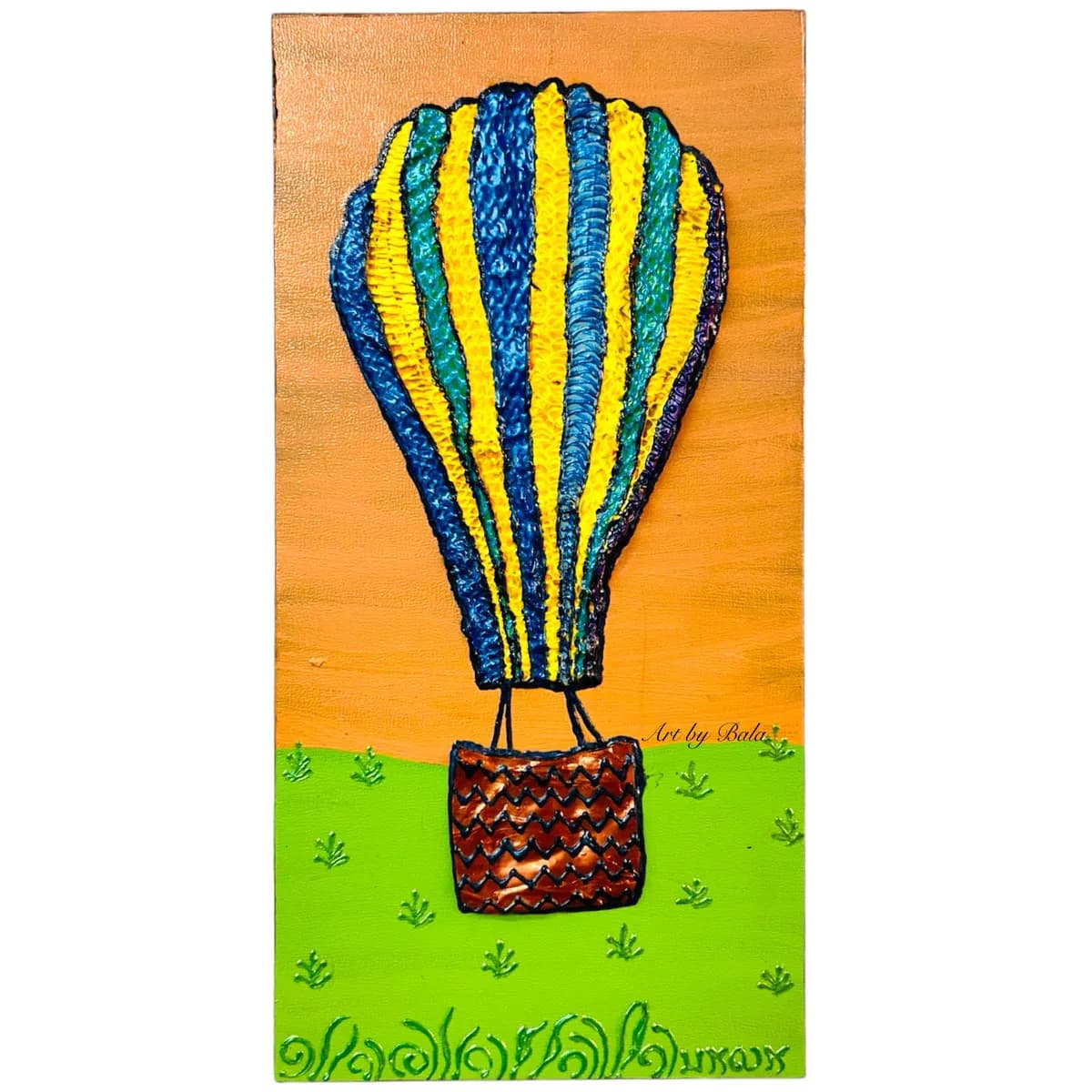 A textured mixed media artwork depicts a vibrant hot air balloon with blue and yellow stripes floating above a green grassy field.