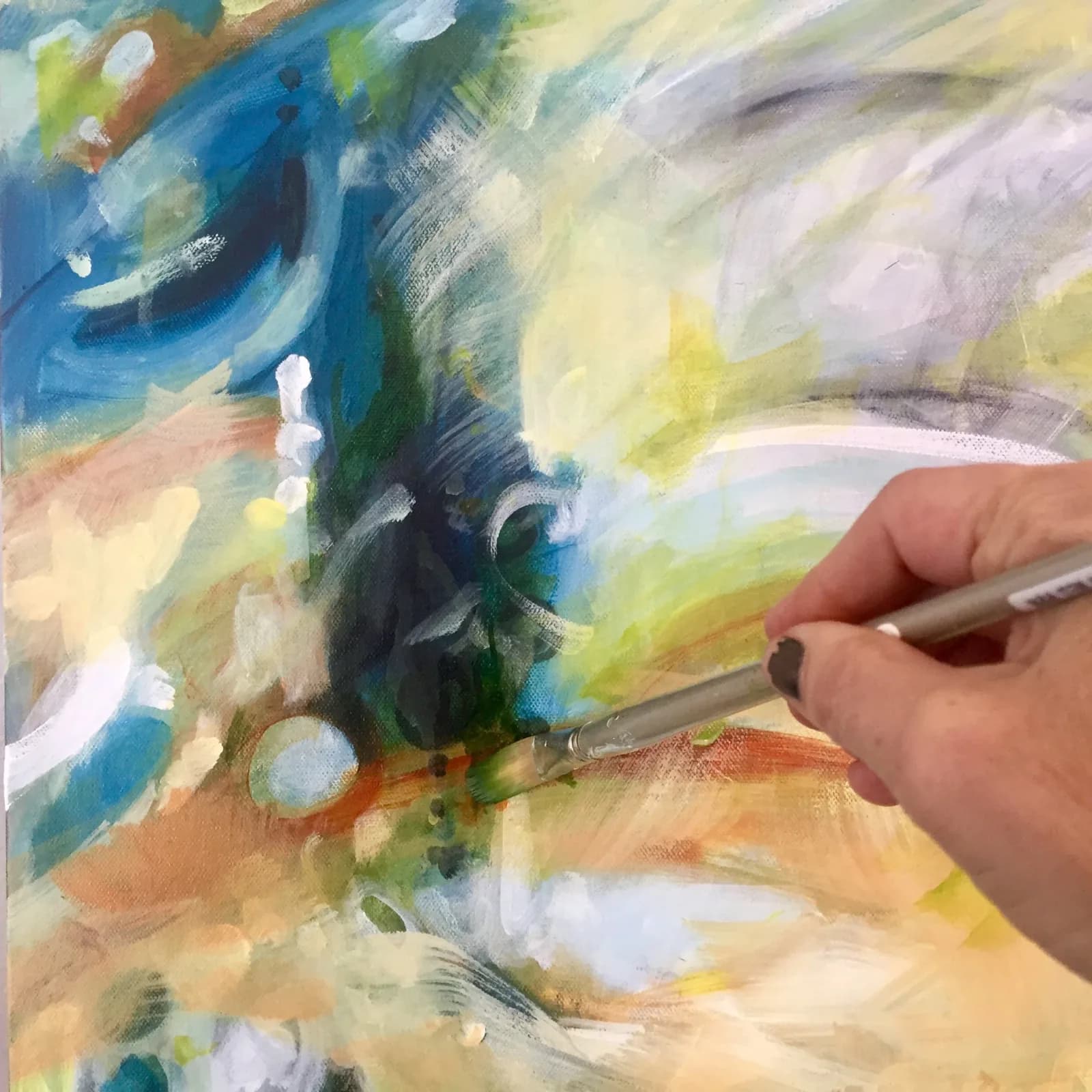 An abstract painting in progress with a hand holding a brush, featuring Calypso and Antique Brass colors.