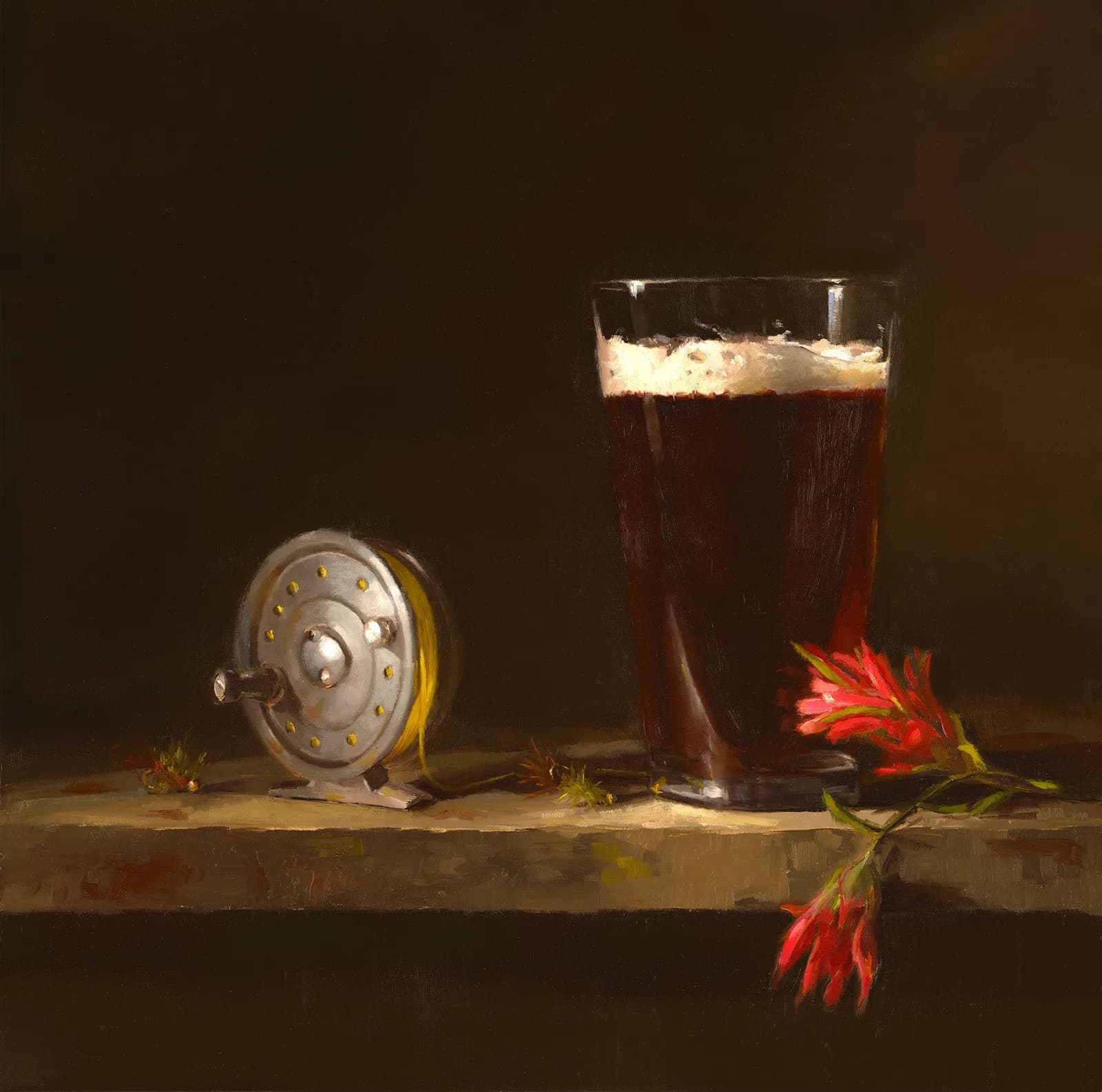 A still life painting features a fishing reel, a glass of dark beer, and Indian paintbrush flowers on a wooden surface.