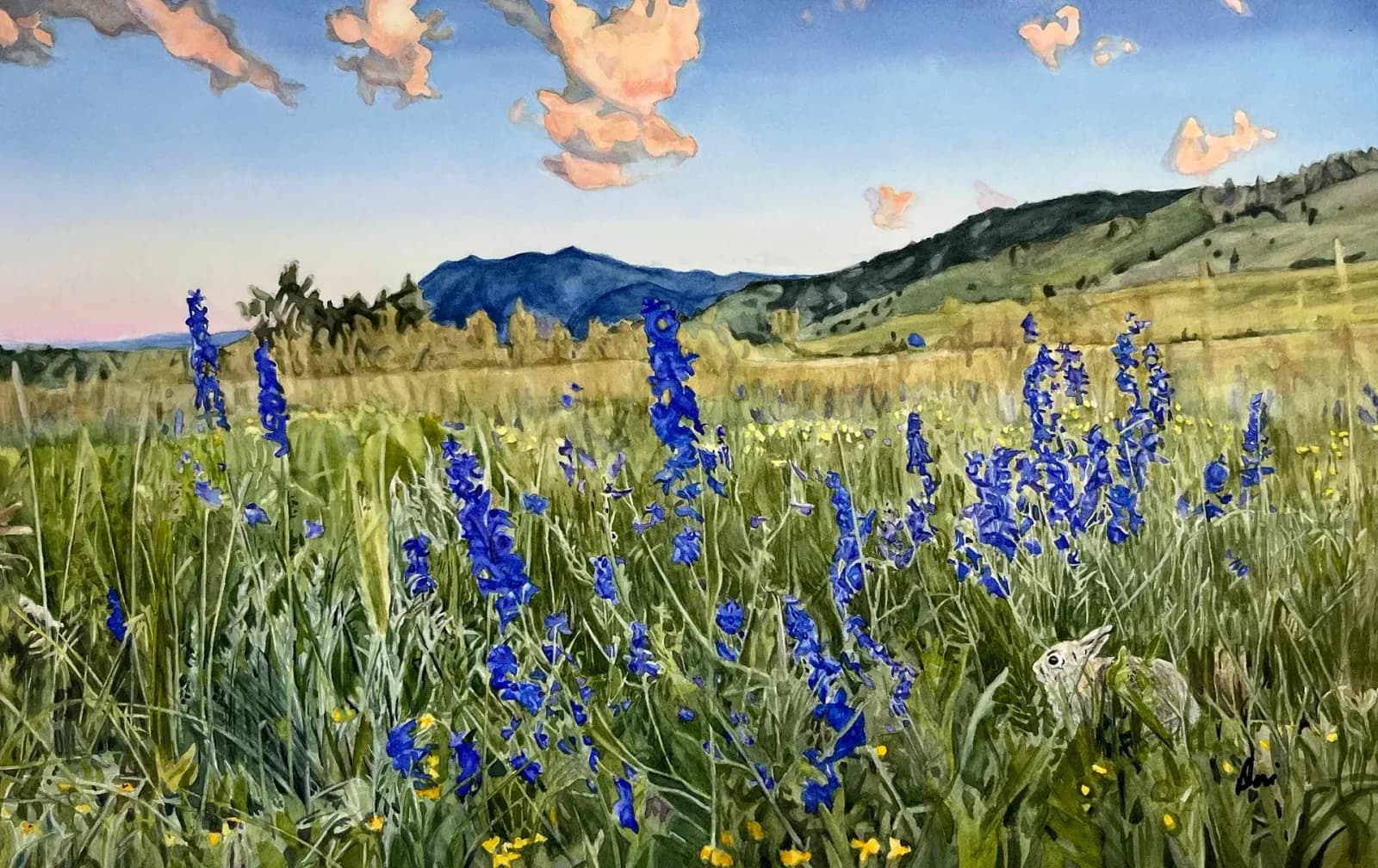 A watercolor painting captures a meadow filled with blue delphinium and yellow wildflowers, with a rabbit peeking out, under a sky with pink clouds.