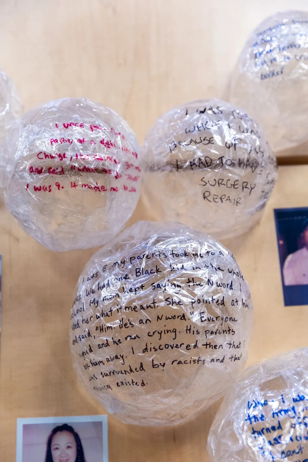 Mixed media spheres with handwritten personal narratives in Midnight, Martinique, Wafer, Pink Swan, Cold Turkey, and Del Rio colors.