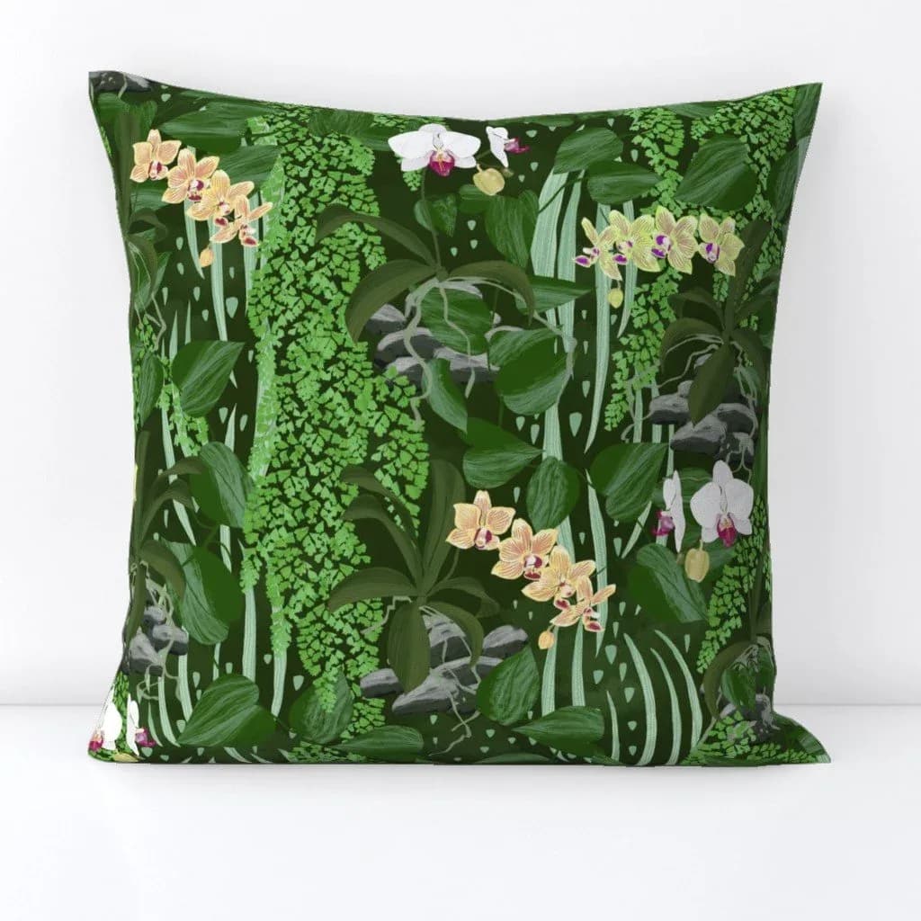 A vibrant floral painting features yellow and white orchids amidst lush green jungle foliage and vines.