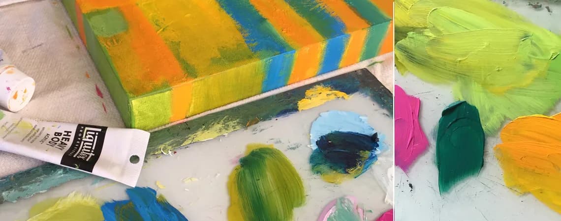 A painting in progress with tubes of acrylic paint and a palette of vibrant colors.