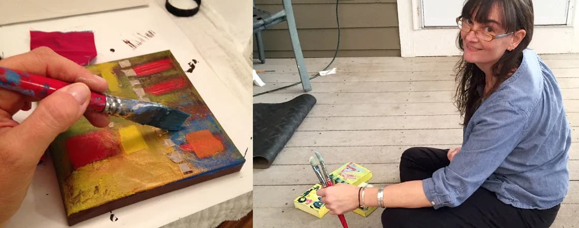 An artist works on an abstract painting with bold colors and textures in a studio setting.