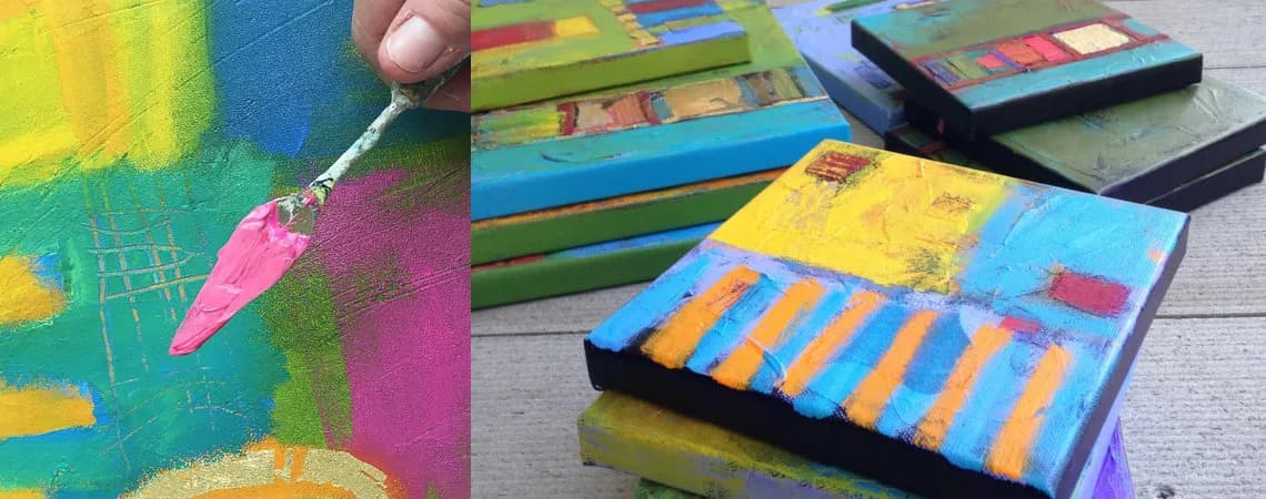 An artist uses a palette knife to apply pink paint to a vibrant, textured abstract canvas, with other finished works in the background.