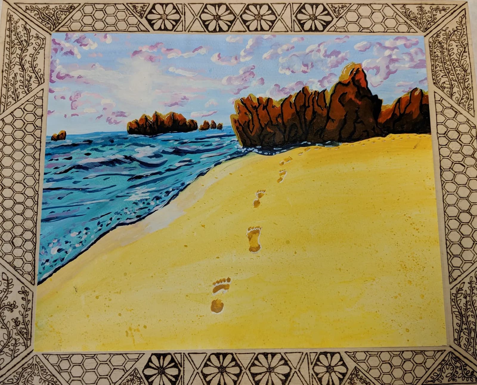 Footprints lead across a sandy beach toward the ocean under a cloudy sky, rendered in watercolor.