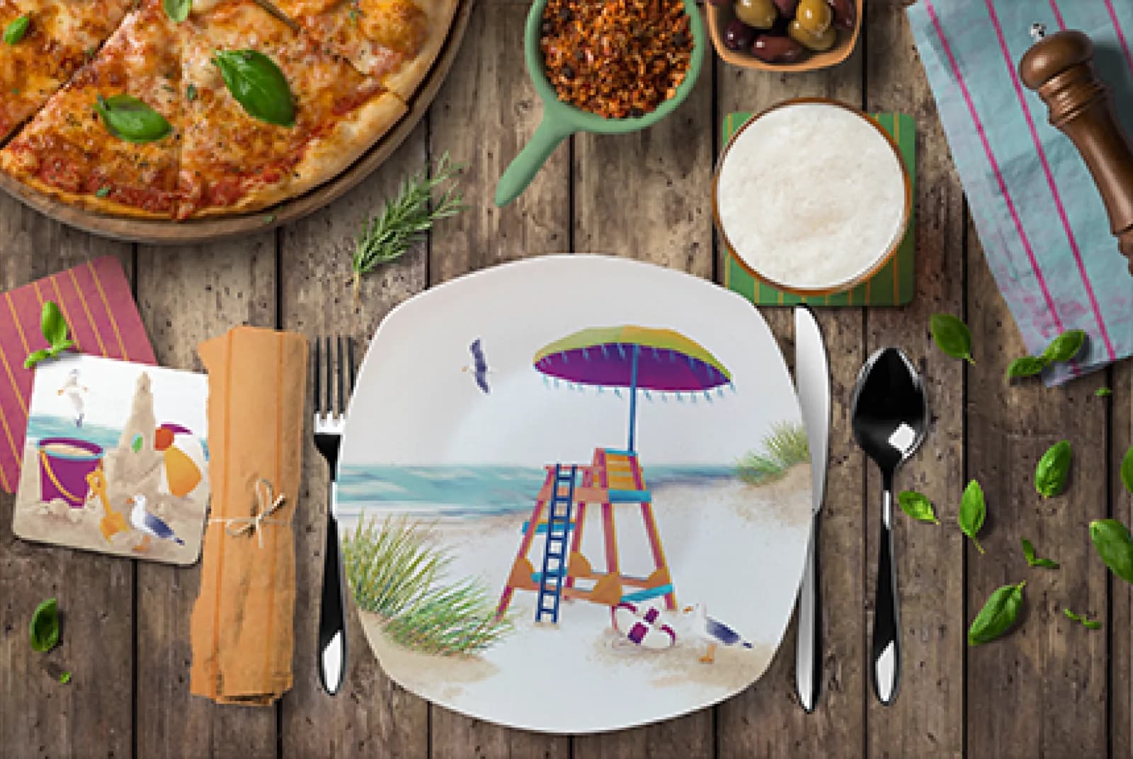 A folk art ceramic plate depicts a beach scene with a lifeguard stand and umbrella, set for a summer meal.