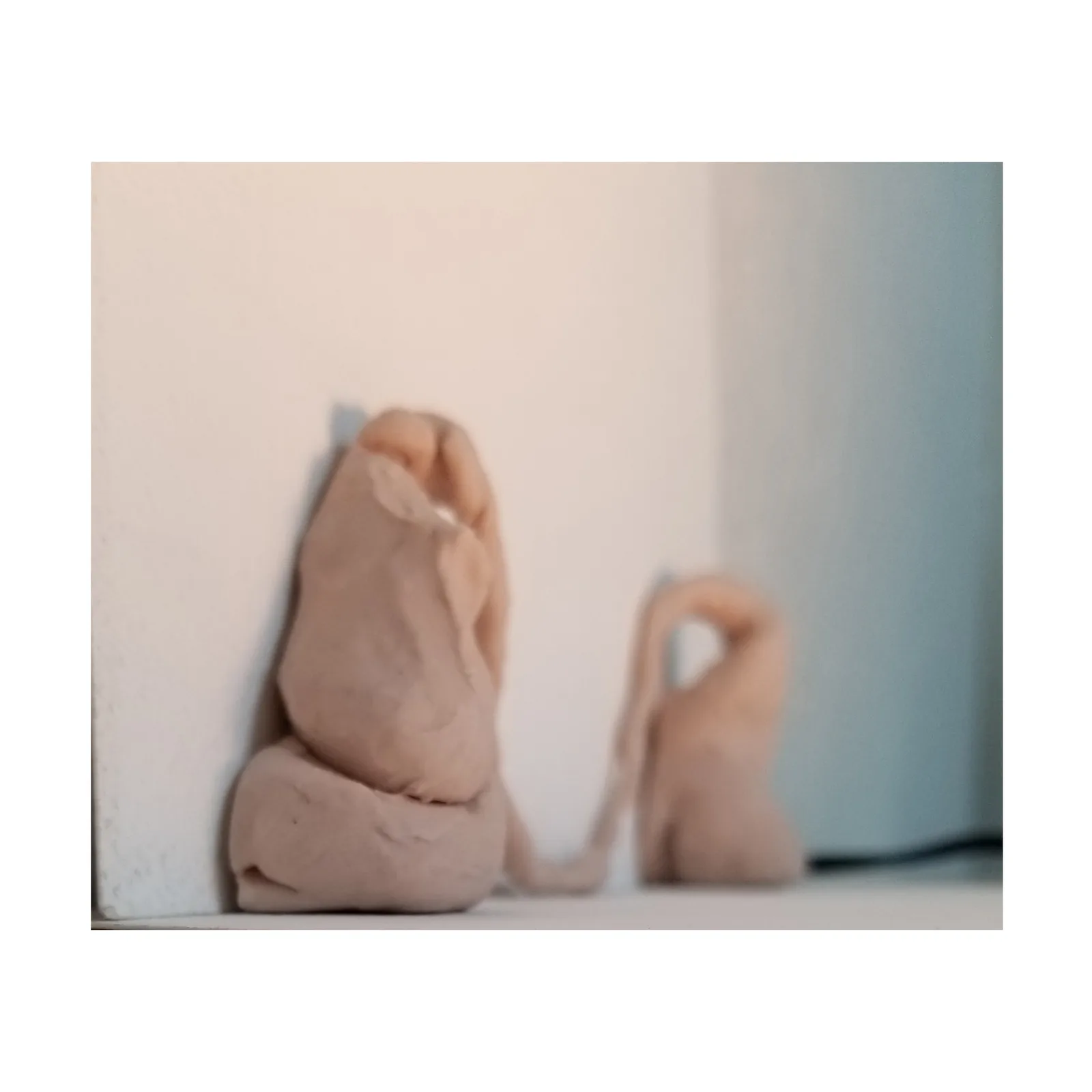 Abstract clay figures in progress, rendered in a neutral palette with a focus on form.