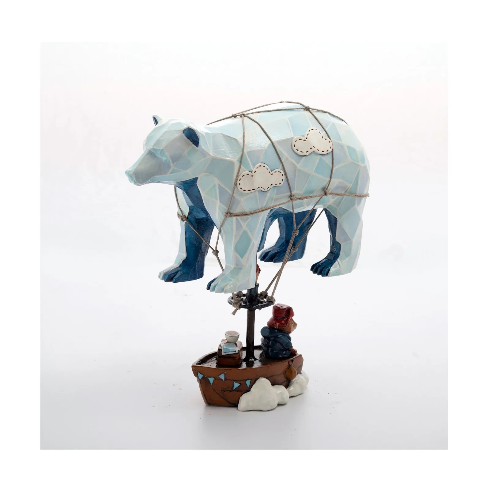 A whimsical folk art sculpture of a polar bear in a hot air balloon, featuring a palette of Nile Blue and Saddle.