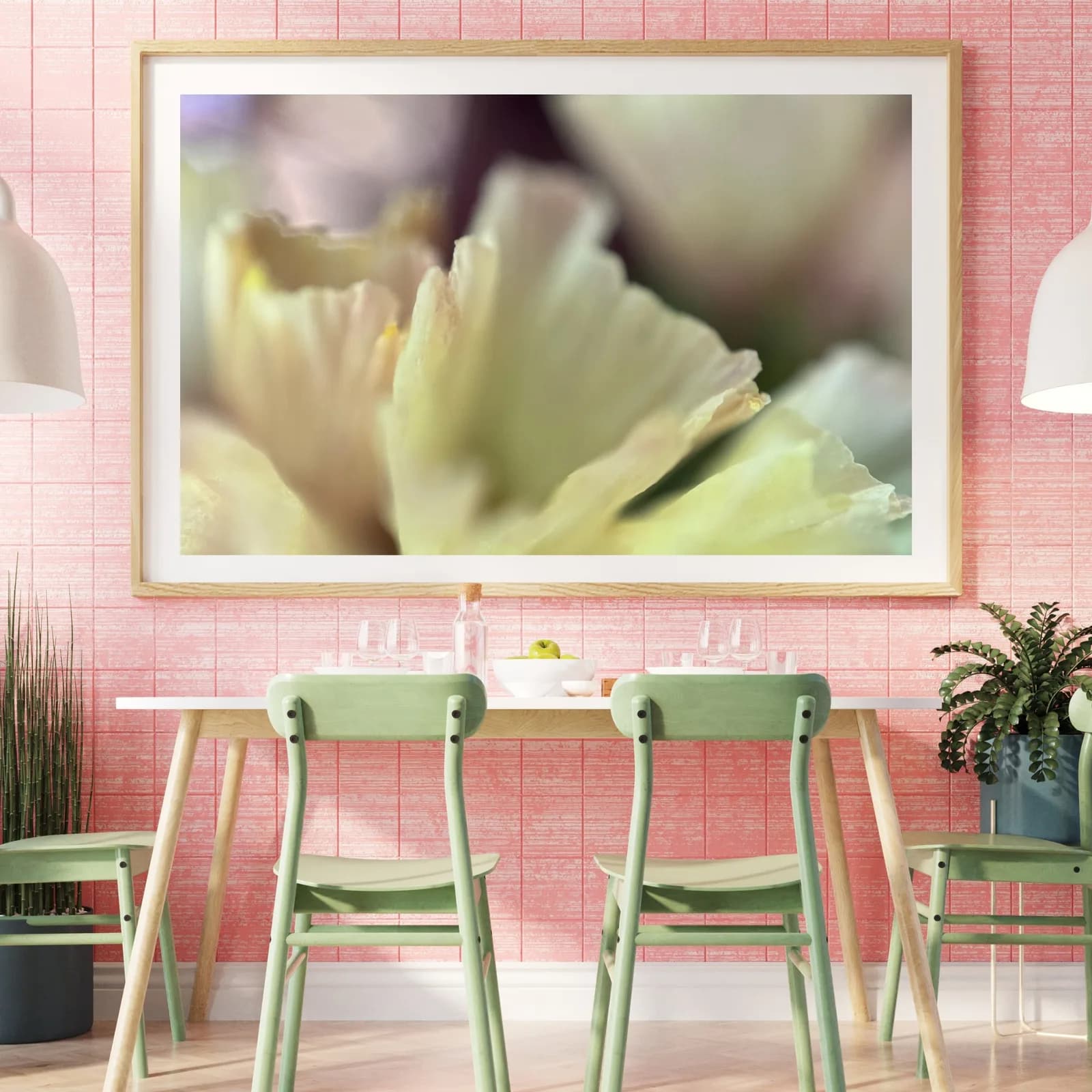 A close-up photograph of a pale yellow flower is displayed above a dining table with green chairs.