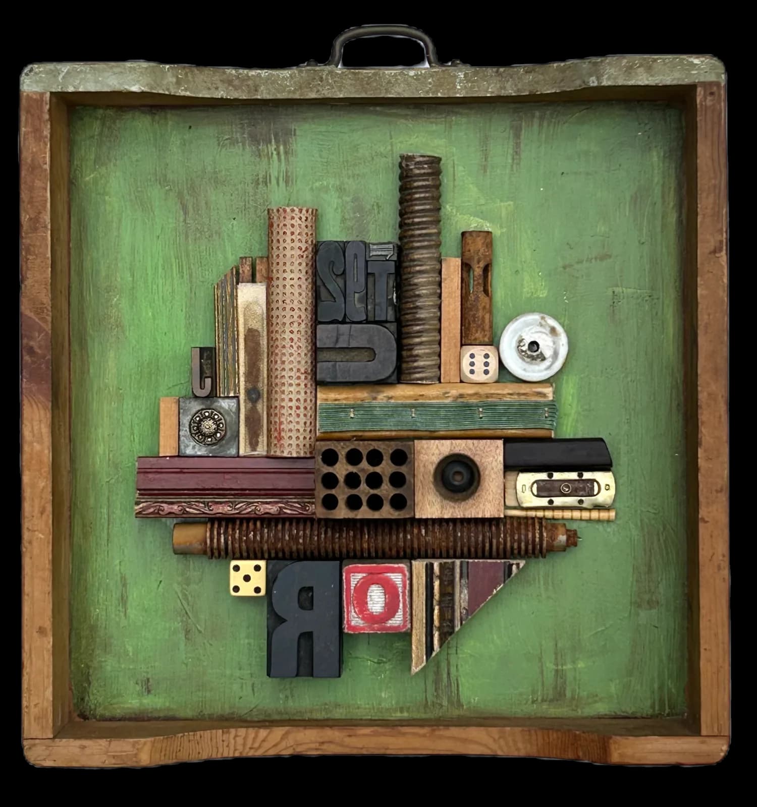 An abstract assemblage of found objects and typography in shades of Highland and Go Ben, presented in a wooden frame.