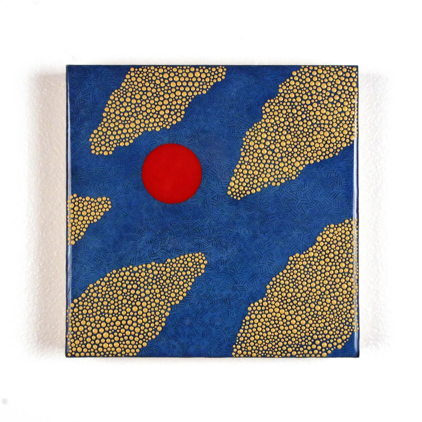 An abstract painting features a red circle against a blue background with yellow dotted cloud-like shapes.