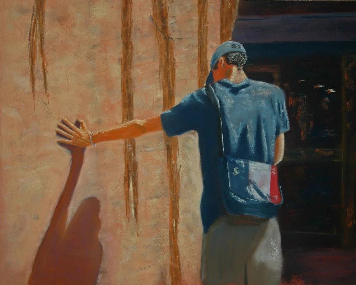 A figure in a blue shirt and cap touches a textured wall, casting a long shadow, rendered in expressive pastels.