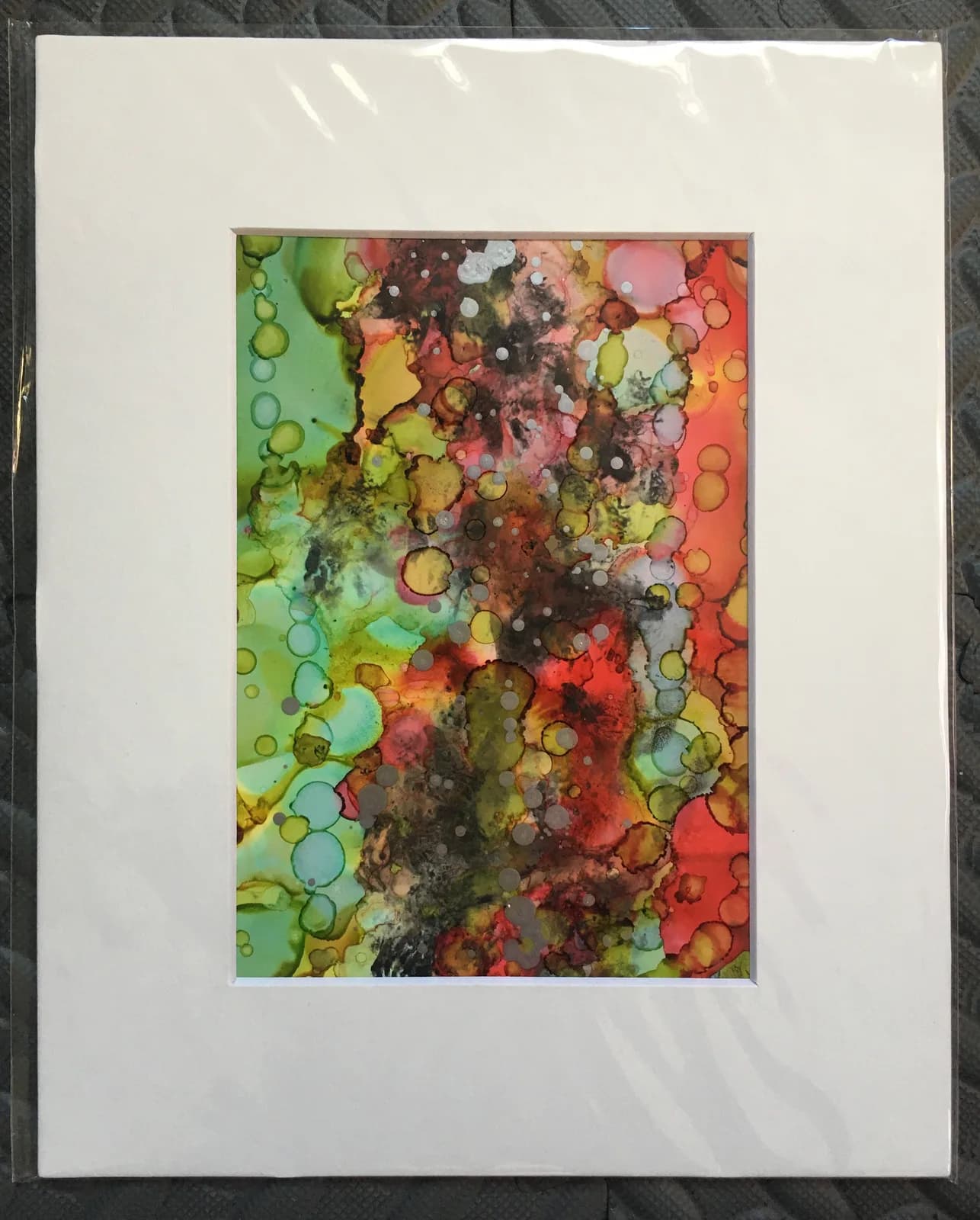 An abstract ink painting features vibrant organic forms in shades of Crail, Antique Brass, and Timberwolf.