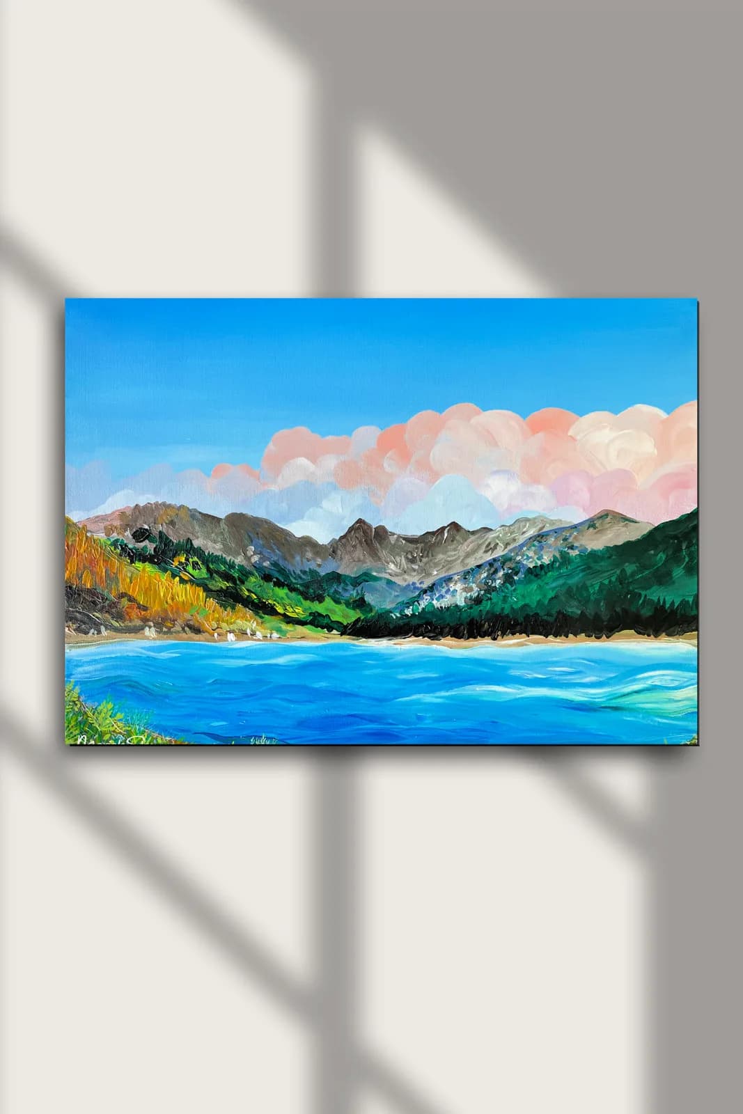 An impressionistic oil painting depicts a vibrant landscape with a bright blue lake, green mountains, and soft pink clouds under a clear sky.