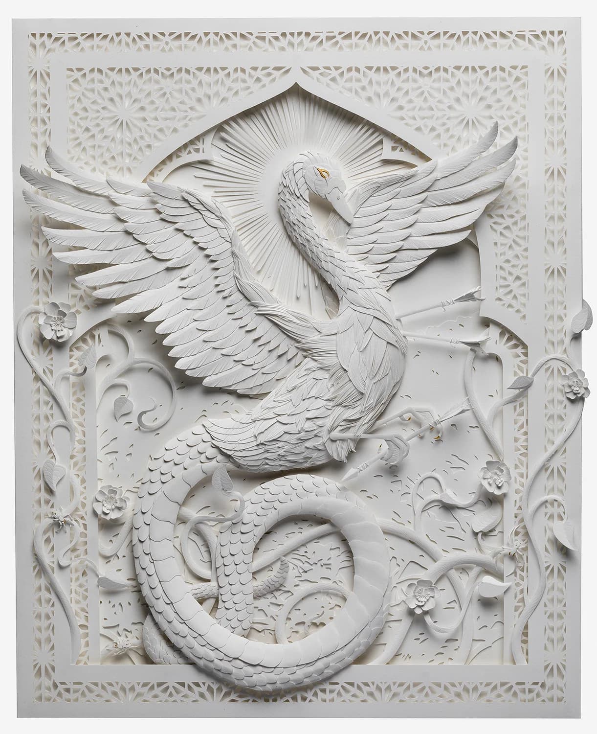 A white paper sculpture depicts a swan and a coiled dragon with intricate floral and geometric details.