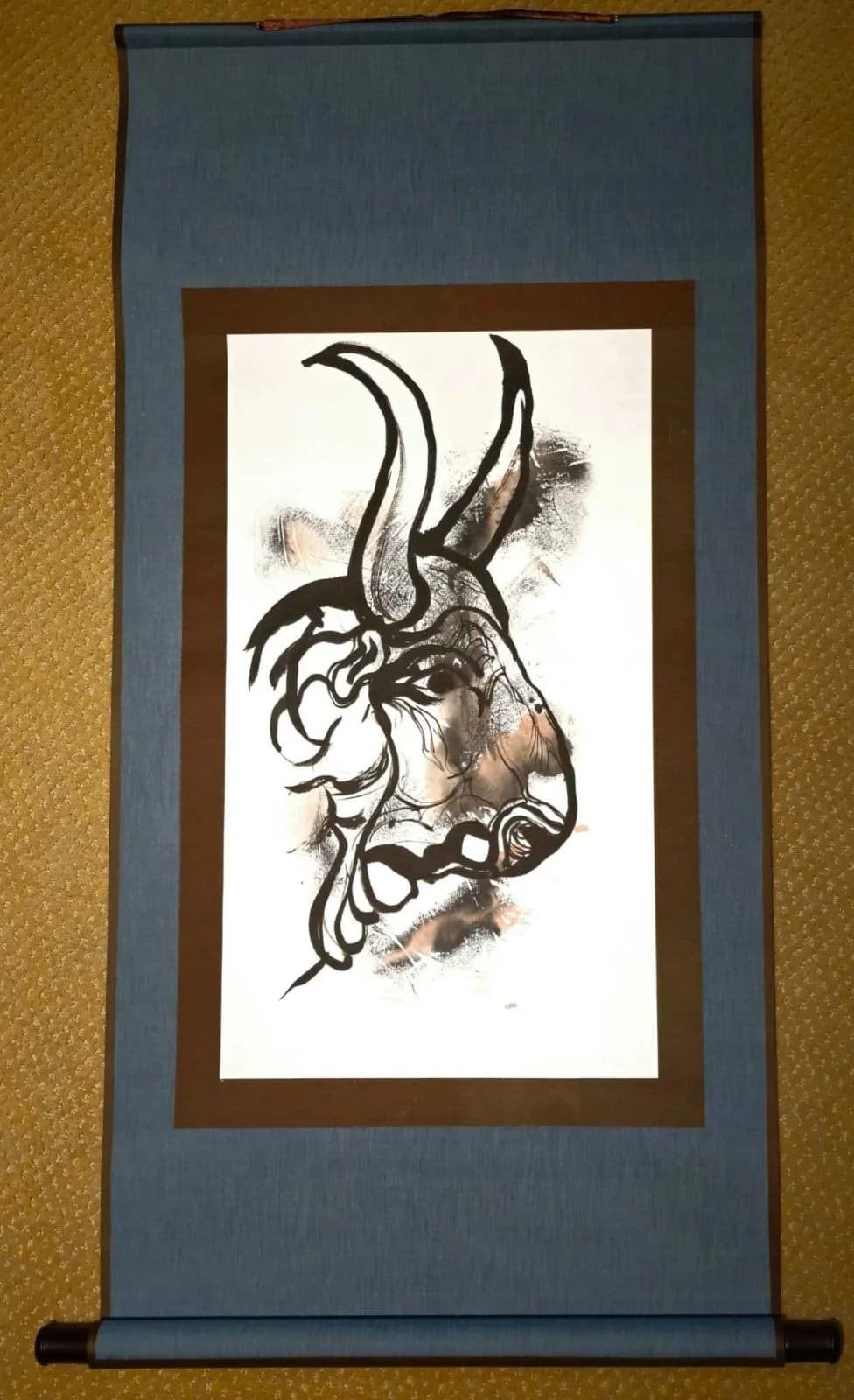 An expressive ink drawing of a bull's head on paper, rendered with bold lines and washes.