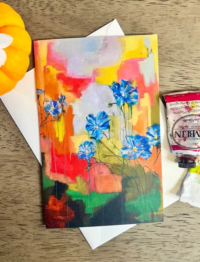 Vibrant abstract floral painting in oil and acrylic with blue flowers and a colorful background.