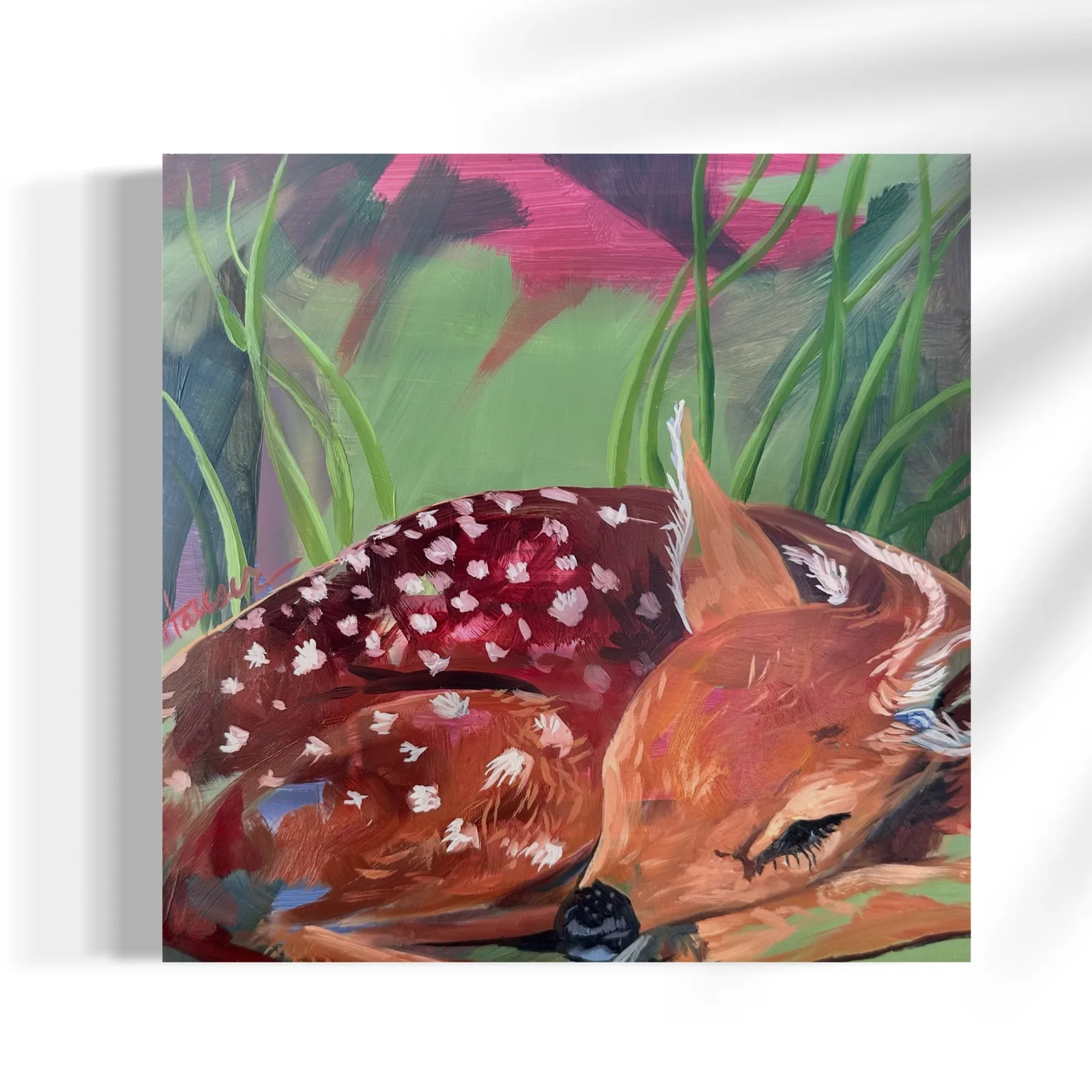 An expressive oil painting depicts a sleeping fawn nestled in green grass with hints of pink.