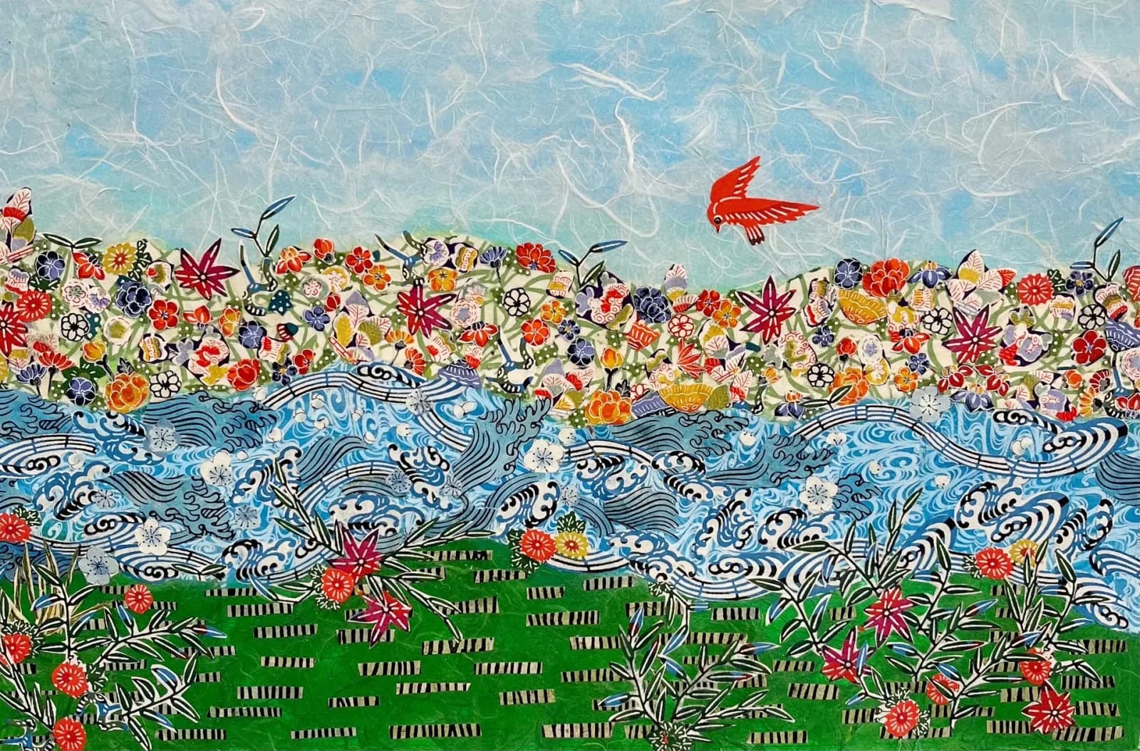A mixed media collage on paper depicts a vibrant landscape with a red bird flying over a floral hill and blue water.