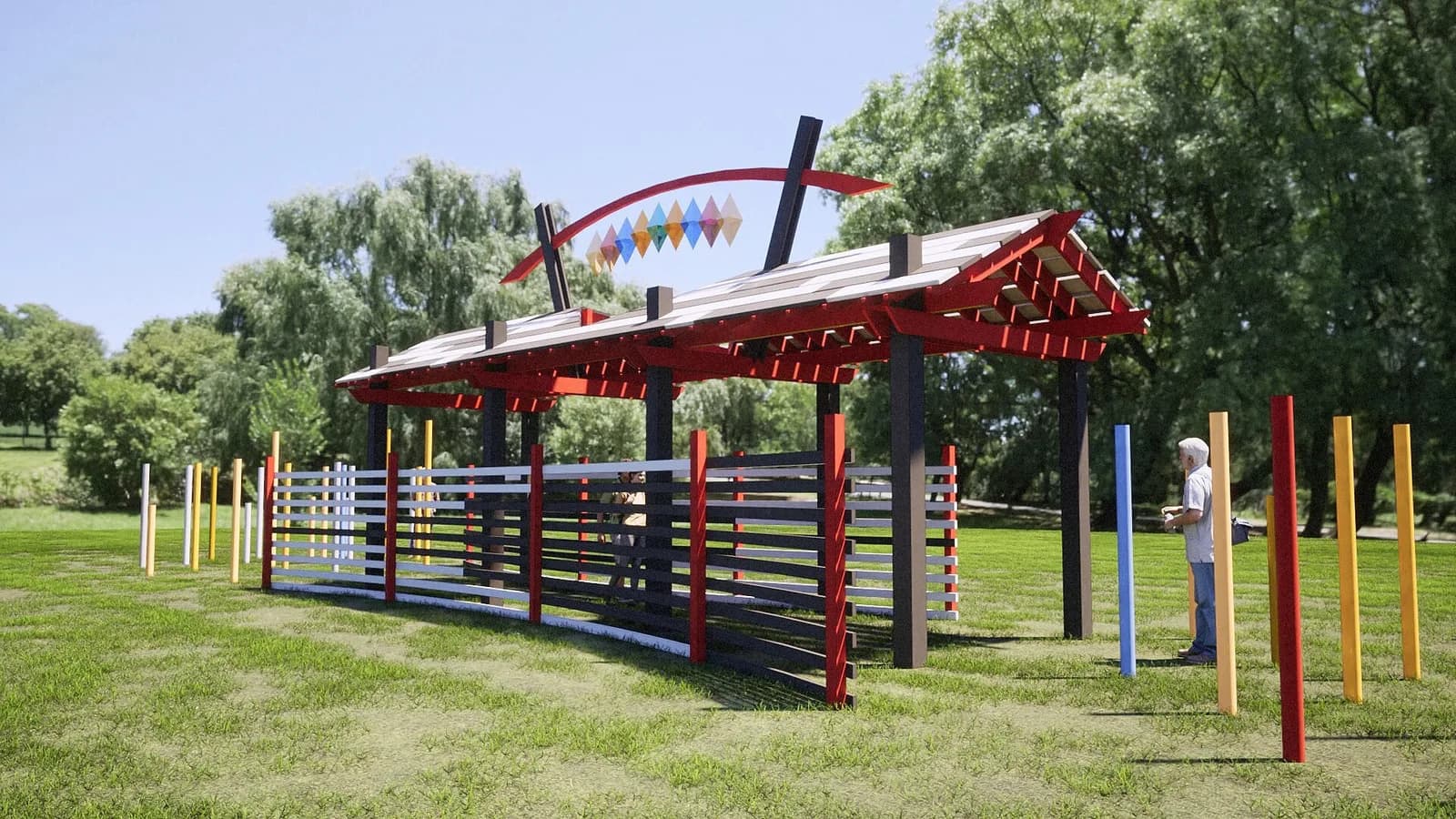 An abstract metal installation features a red-roofed structure with colorful diamond shapes and surrounding posts in a park setting.