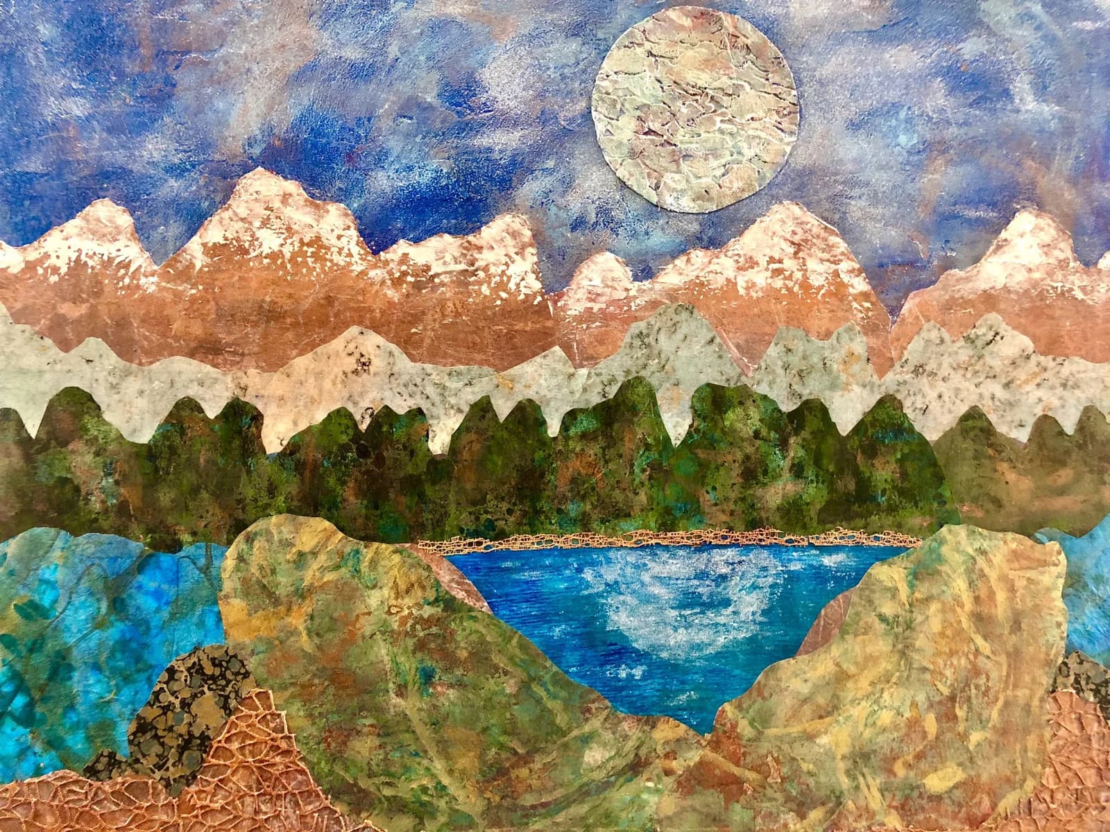 A mixed media collage depicts a serene mountain landscape with a lake under a full moon, rendered in earthy tones.