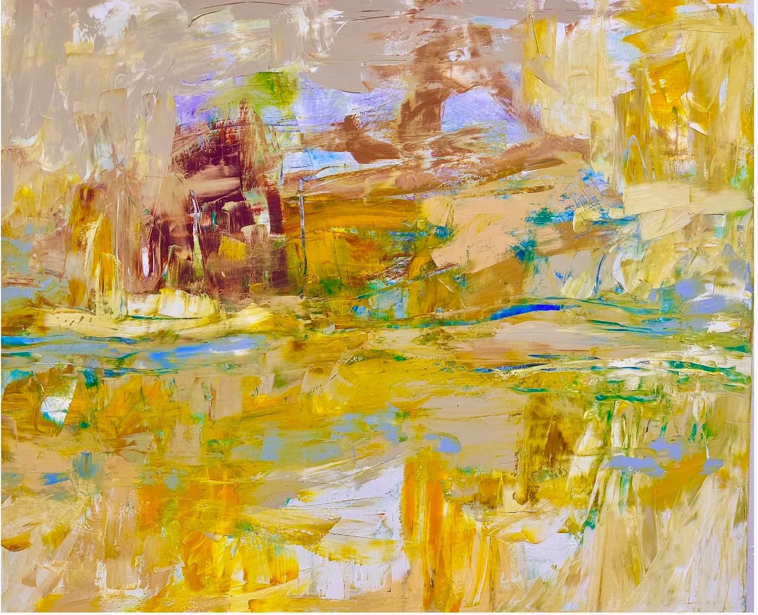 An abstract landscape painting in oil and acrylic features textured brushstrokes in golden hues with hints of blue and green.